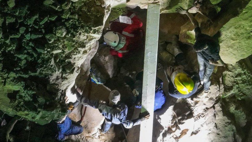 An aerial picture shows members of Iraqi emergency services scanning the rubble for victims following a landslide at the Qattarat al-Imam Ali shrine on the outskirts of the holy city of Karbala, late on August 20, 2022.