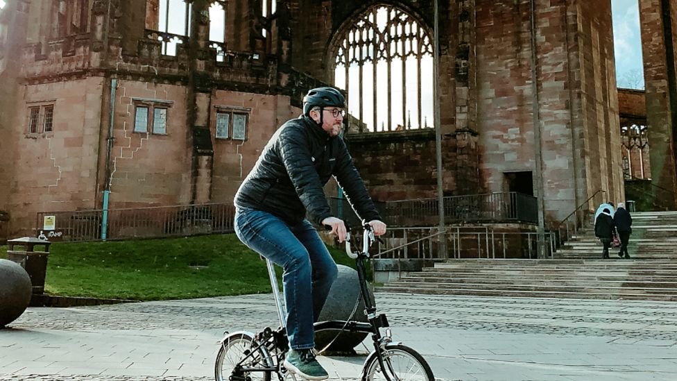 Adam Tranter riding a fold-up bike