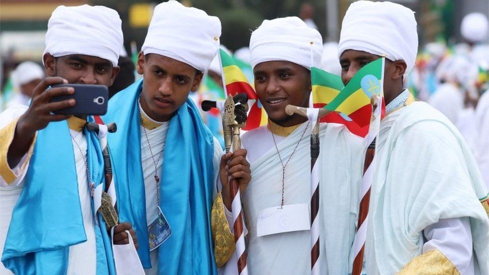 Ethiopian Orthodox faithful take a selfie during the Meskel Festival to commemorate the discovery of the true cross on which Jesus Christ was crucified on, in Addis Ababa, Ethiopia, September 26, 2020.
