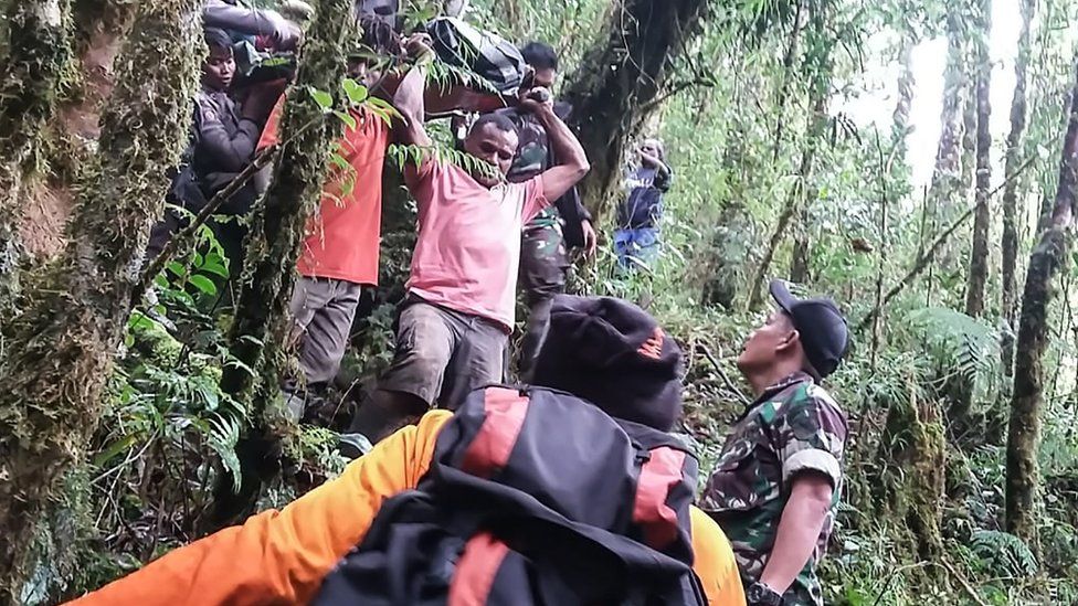Papua's Cendrawasih Military Command shows a rescue team evacuating the sole survivor from the crash site of a Swiss-made Pilatus aircraft at Menuk mountain in Oksibil.