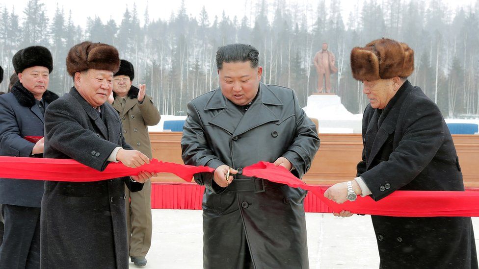 North Korean leader Kim Jong Un cuts the ribbon during a ceremony at the township of Samjiyon County