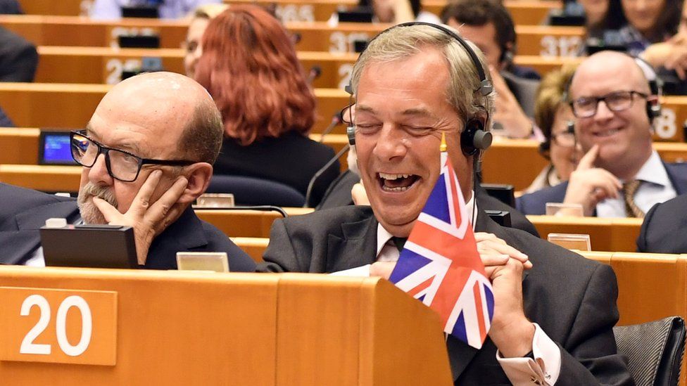 Nigel Farage seated at the European Parliament