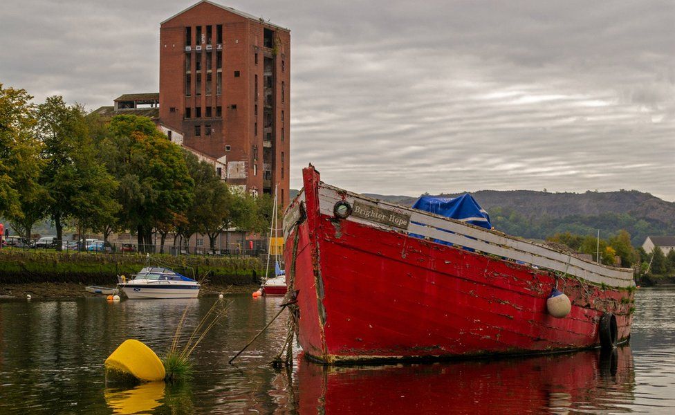 Brigher Hope, photographed at low tide on the River Leven with the old mill building in the background,