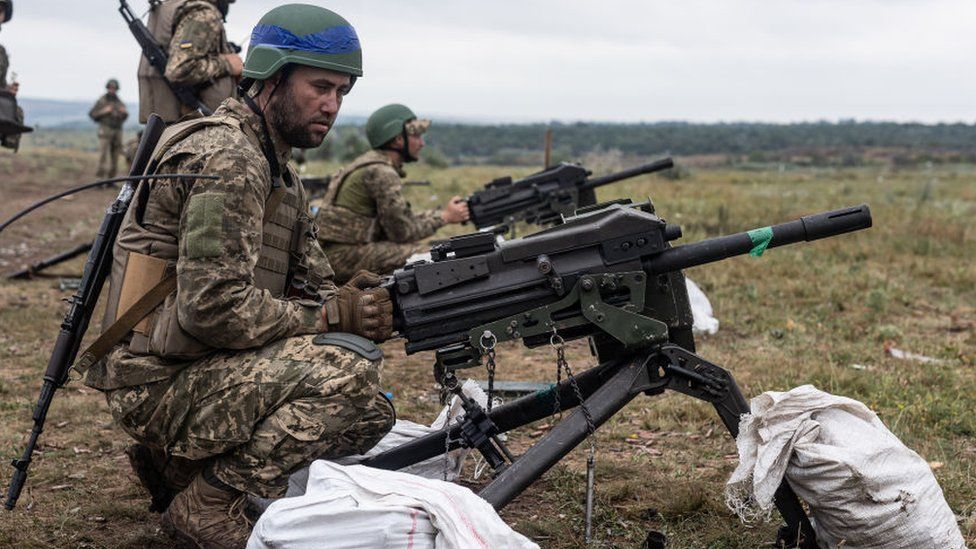 A Ukrainian soldier firing a mounted machine gun