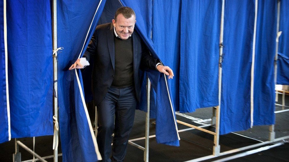 Danish Prime Minister Lars Lokke Rasmussen leaves a voting booth