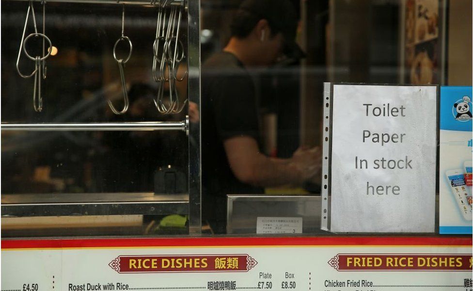 A sign in the window of a Chinese restaurant and takeaway shop alerts people that they have toilet rolls for sale, in London on March 19, 2020. - Britain's supermarkets on Wednesday stepped up efforts to safeguard supplies, especially for vulnerable and elderly customers, as the sector battles stockpiling caused by coronavirus panic. (Photo by ISABEL INFANTES / AFP) (Photo by ISABEL INFANTES/AFP via Getty Images)