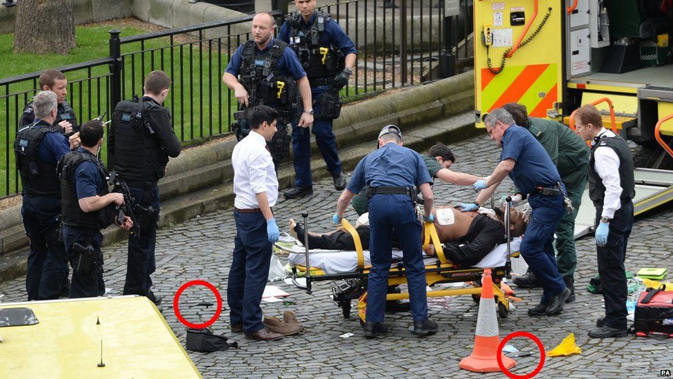 Emergency services at the scene while two knives lie on the ground outside the Palace of Westminster