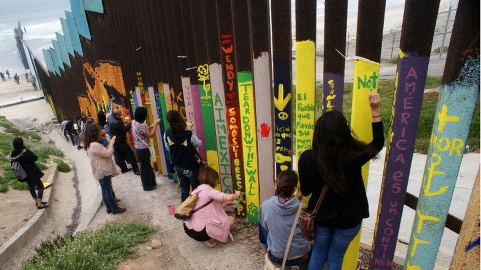 Mexican citizens paint on the border wall between Mexico and the United States in Tijuana, Mexico, 3 June 2017