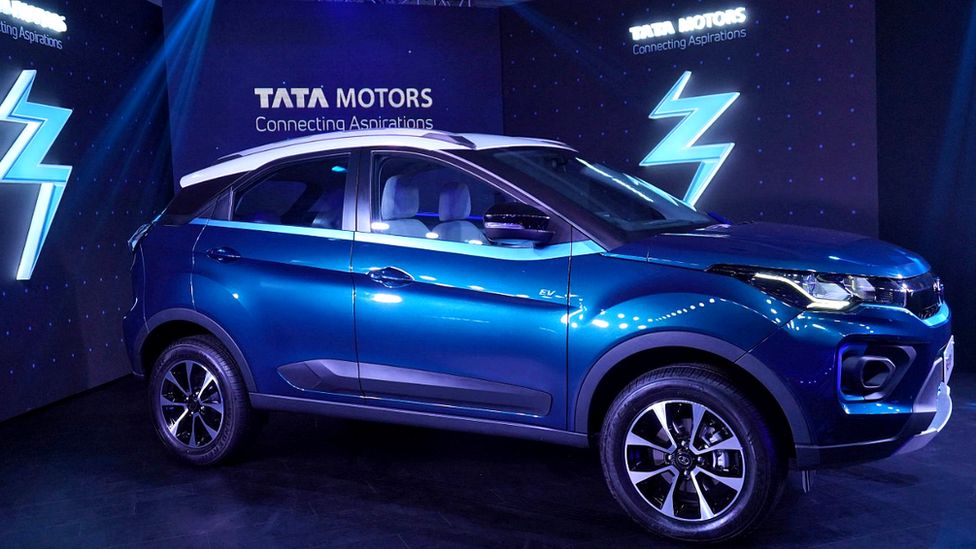 Tata electric vehicle under blue lights in a showroom