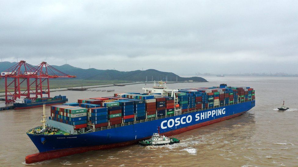Aerial view of a Cosco France container ship berthing with the help of tugboats at the Port of Ningbo-Zhoushan on September 1, 2019 in Zhoushan, Zhejiang Province of China.
