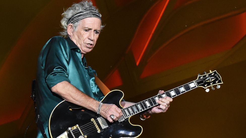 Keith Richards performing with his guitar