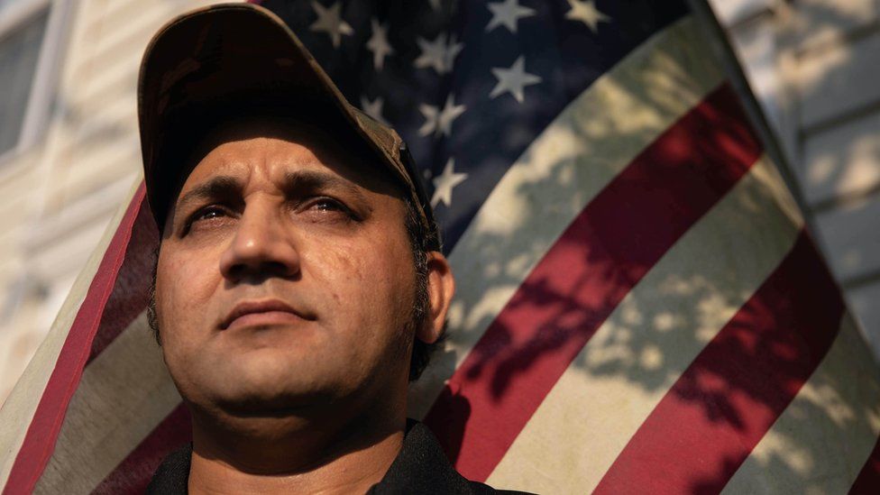 Zia Ghafoori stands in front of his home in North Carolina