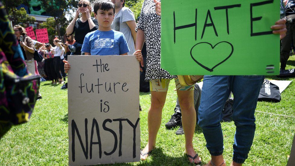 Young boy holding a sign saying 'The future is nasty' at a rally against the inauguration of US President Donald Trump outside the State Library in Melbourne, Victoria, Australia, 21 January 2017