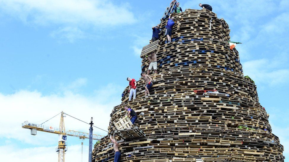Final preparation takes place for the bonfire on Sandy Row in Belfast in July 2017