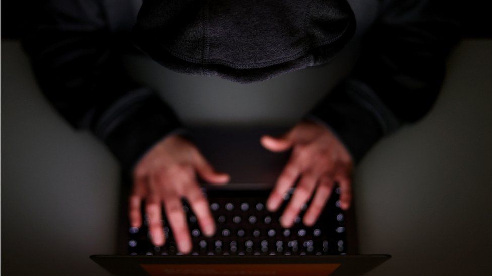 A generic image of an anonymous man at a computer