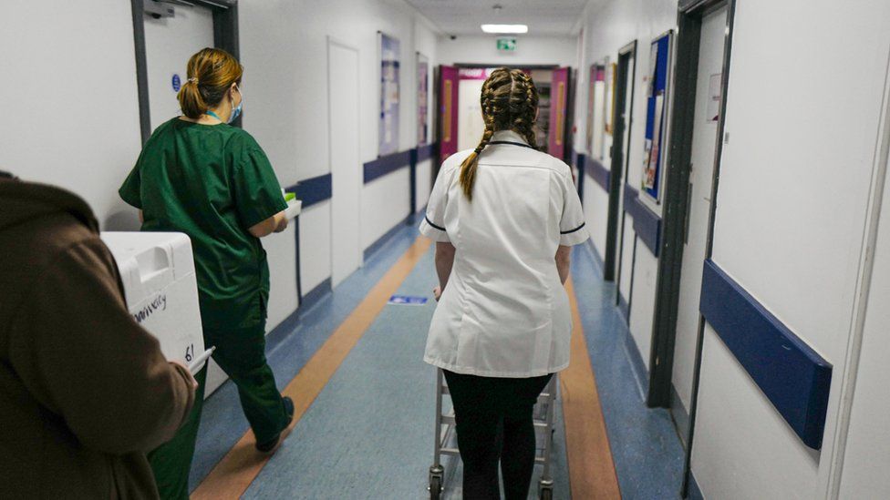 Health and social care staff walking along a corridor