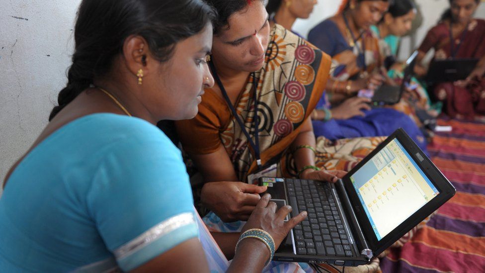 Indian villagers from a self-help group with laptops in Bibinagar village outskirts of Hyderabad on 7 March 2013