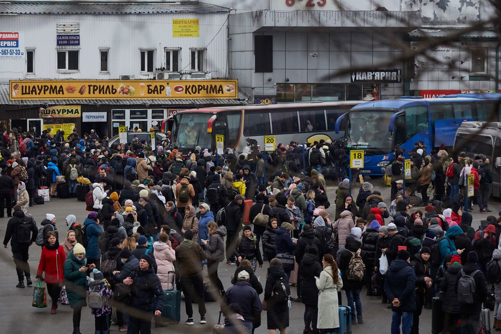 People wait for buses at a bus station as they attempt to evacuate the city on February 24, 2022 in Kyiv, Ukraine