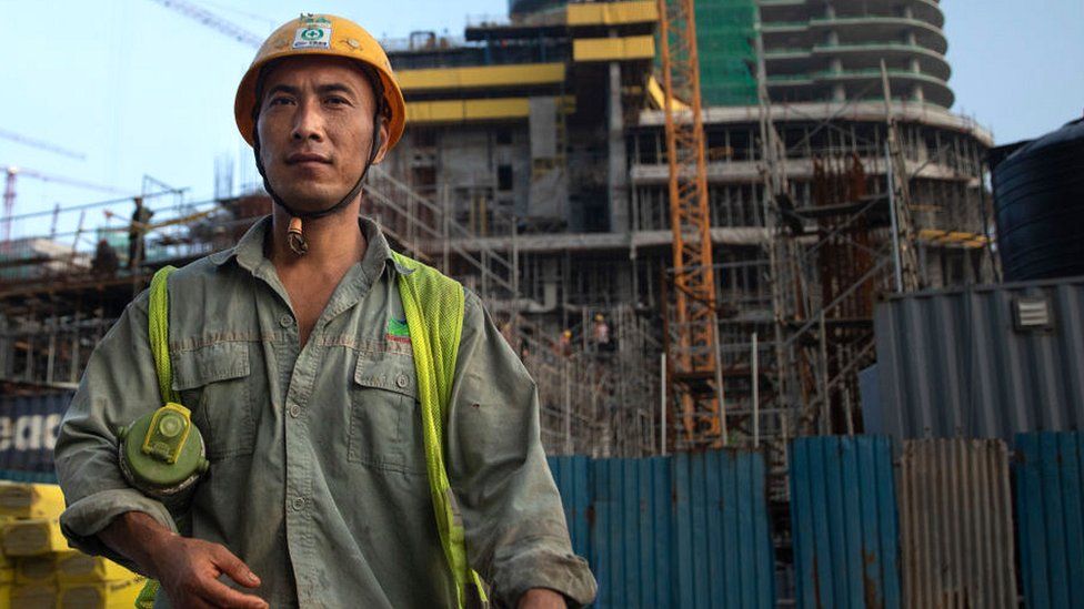 A Chinese construction worker outside a new shopping complex building site in Colombo (2018 photo)