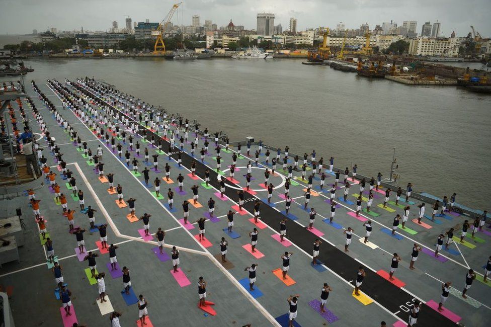 Indian Armed Forces personnel take part in a yoga sesssion to mark International Yoga Day on the Indian Navy aircraft carrier INS Viraat anchored at the Mumbai harbour on June 21, 2017