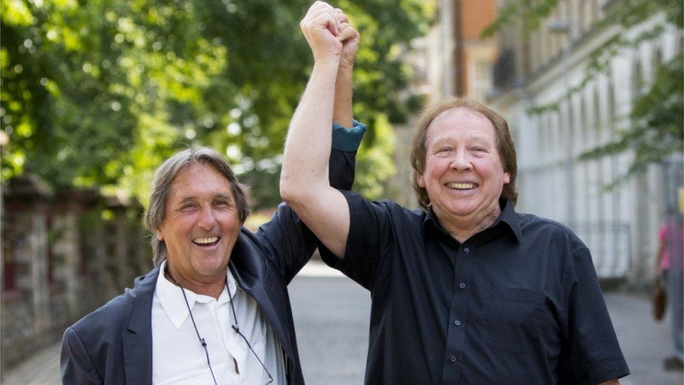 Leonard "Chip" Hawkes (left) and Richard Westwood, who were members of the 1960s pop group The Tremeloes, celebrate outside Reading Crown Court after being formally acquitted