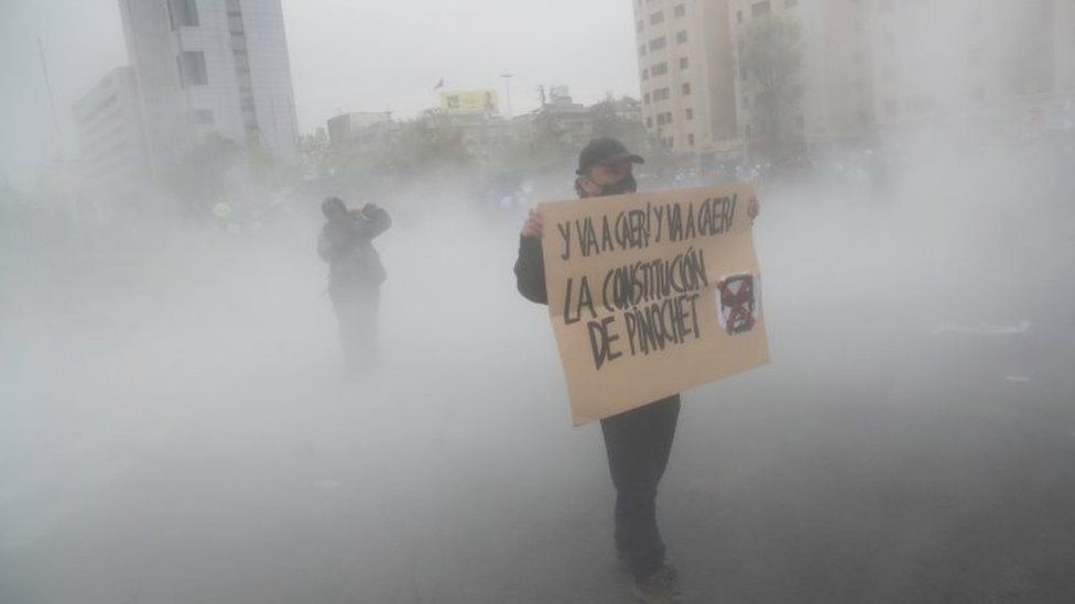 A demonstrator holds a sign during a protest against Chile"s government, in Santiago, Chile September 25, 2020