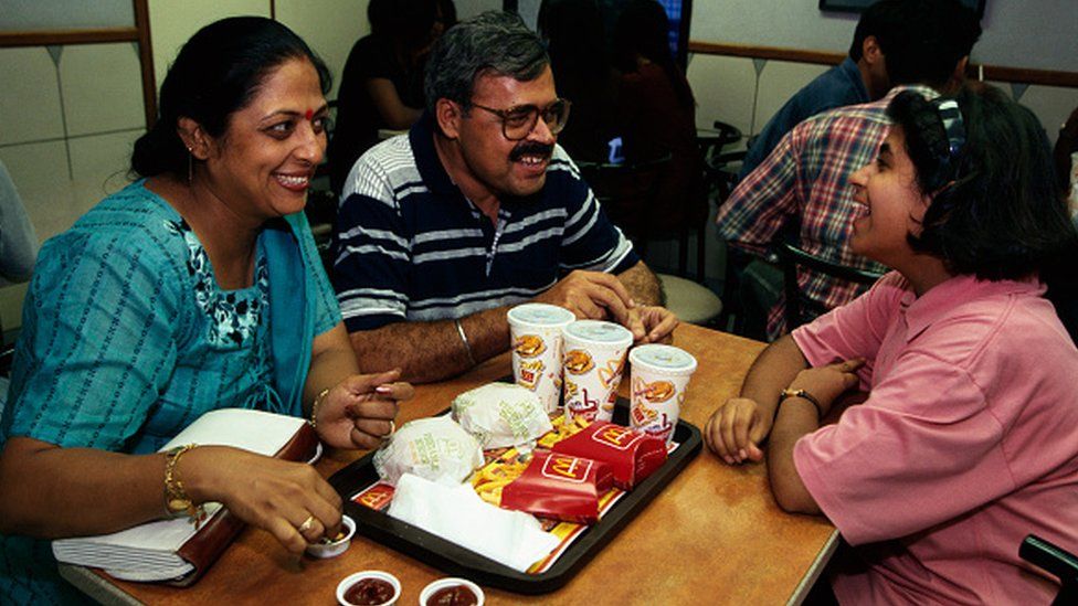 Family eating at India's first McDonald's, which opened in 1996, in the Visant Vihar, upper/middle class area.