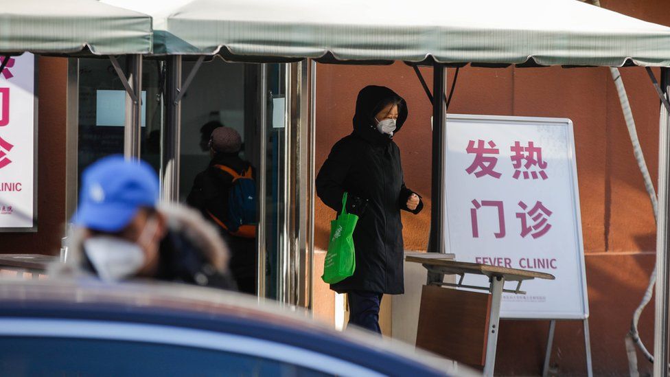 A woman walks out of the fever clinic at Chaoyang hospital in Beijing, China, 21 December 2022. Chinese authorities have reported five more deaths as fever clinics or consulting rooms and hospital beds have been setup around the country. Covid-19 cases continue to spread as Beijing eases pandemic control measures