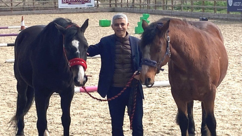 Sadiq Khan poses with two horses in north London