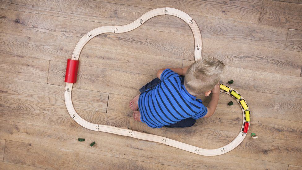 A child playing with a train set
