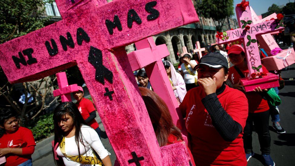 Women carry pink crosses during the "Day without women" protest in Mexico