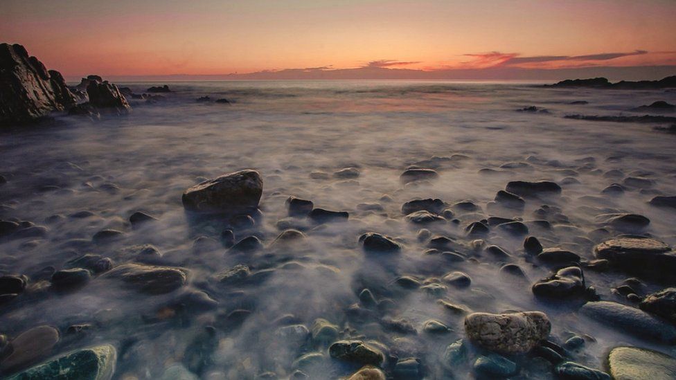 Porth Swtan on Anglesey during sunset - lots of mist among the rocks