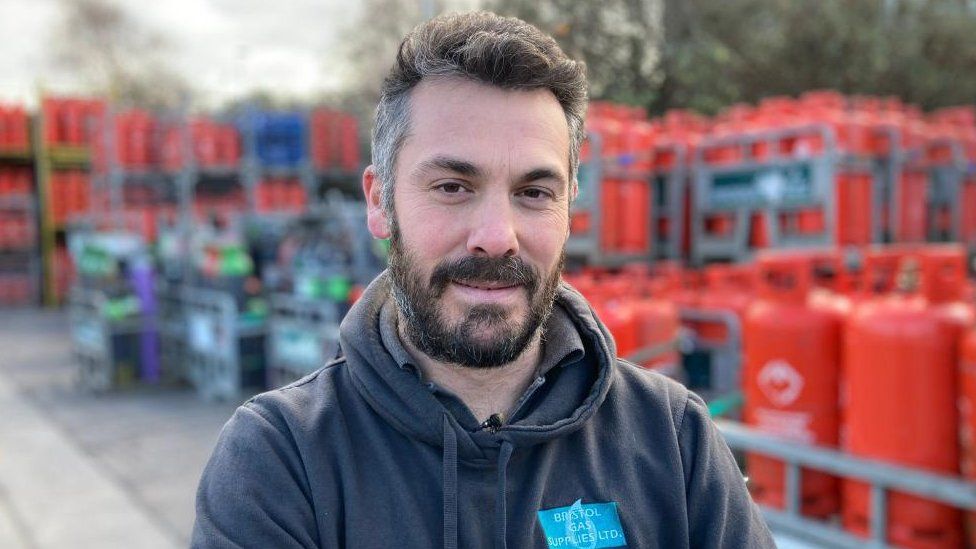 Alex Hignell, director of Bristol Gas Supplies, standing in front of bottles of gas