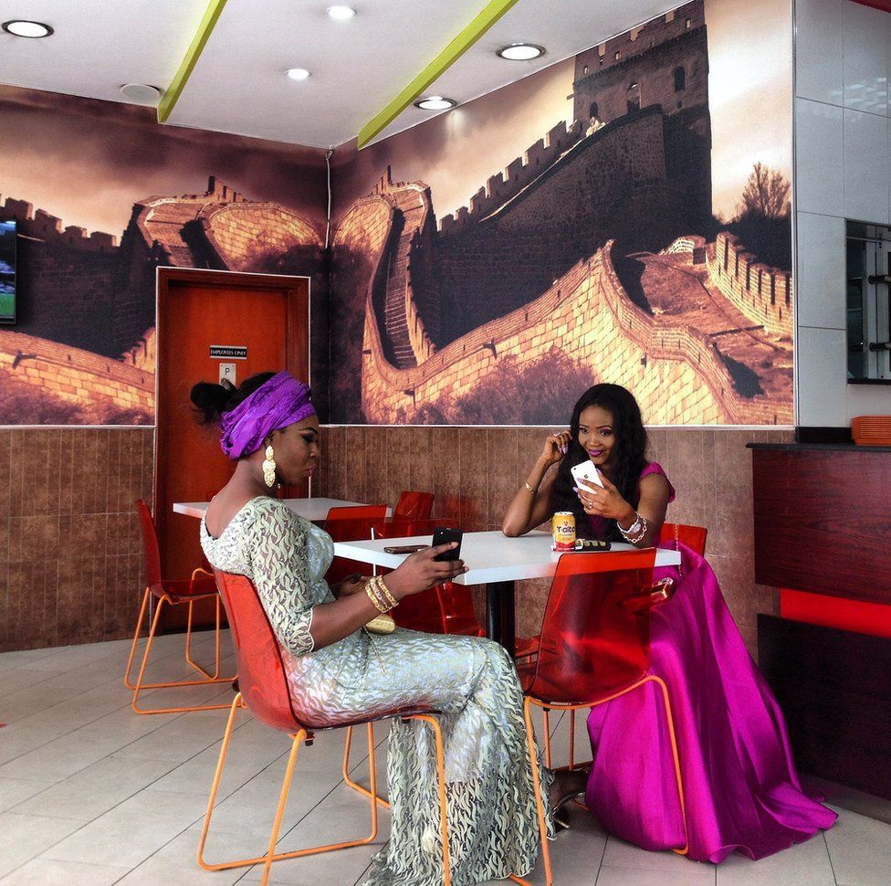 Two women taking selfies in Nigeria