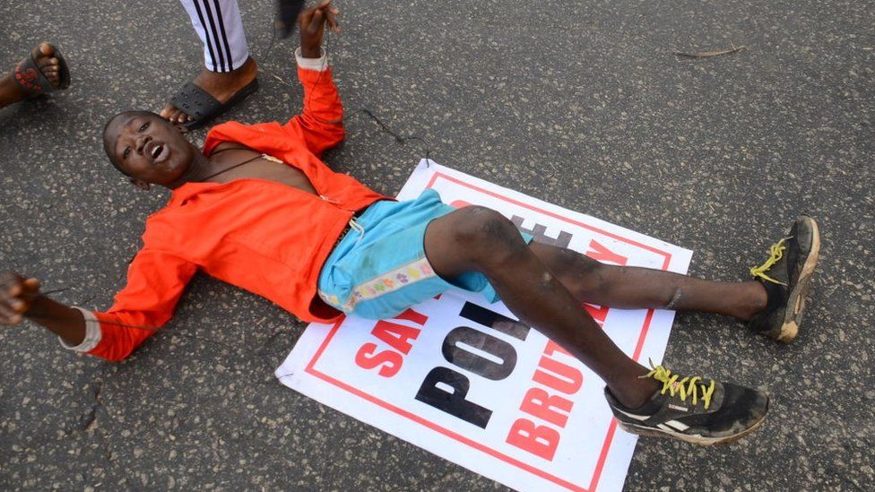 Youths of ENDSARS protesters display their placards in a crowd in support of the ongoing protest against the harassment, killings and brutality of The Nigerian Police Force Unit called Special Anti-Robbery Squad (SARS) at Alawusa bus stop, along Lagos Ibadan-Expressway in Ikeja, on October 13, 2020