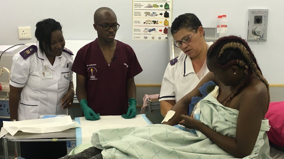 Dr Tjamenda Murangi (C) with nursing staff attending to a patient with an injury on her arm