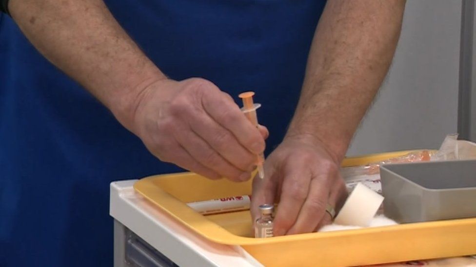 Medical professional giving a vaccine