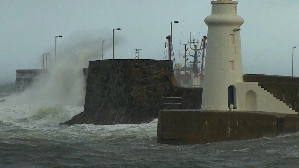 Waves crashing at harbour