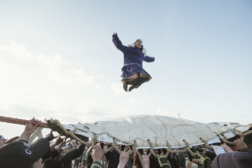 At Nalukataq, the summer whaling festival, the village comes out to celebrate a successful whaling season and to give thanks to the whale for its gift. Here, successful crewmembers do the blanket toss They are thrown up to thirty feet in the air, and depend on everyone's hands to land safely.