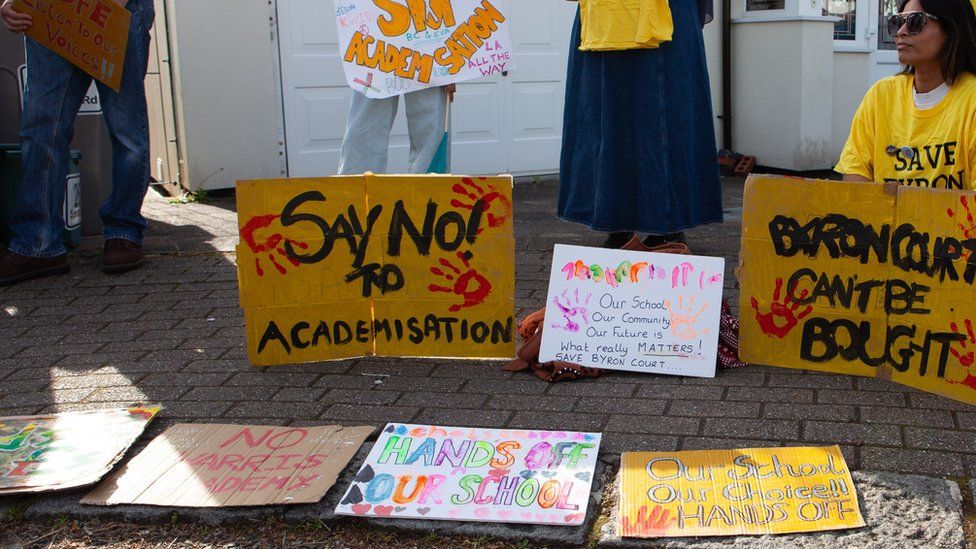 Image showing placards held by children and parents at an earlier protest