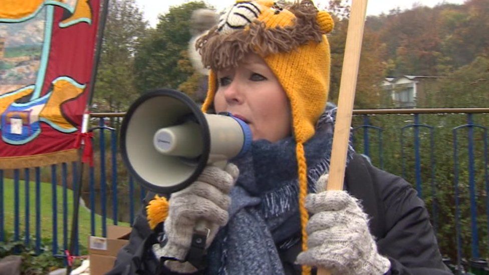 A striking teaching assistant with a megaphone