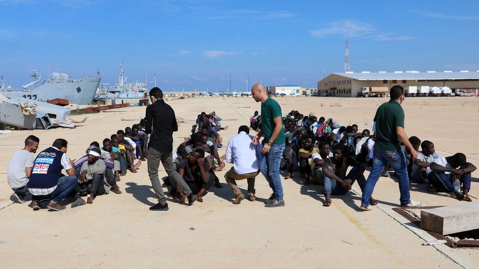 Migrants are checked at a naval base after they were rescued by Libyan coastguard, in Tripoli, Libya