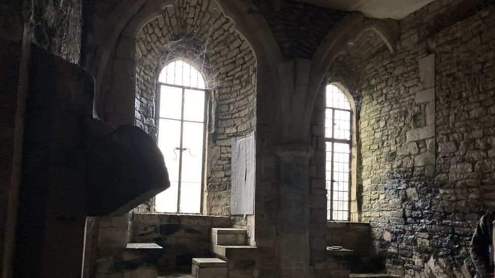 Medieval arched windows in a darkened medieval room