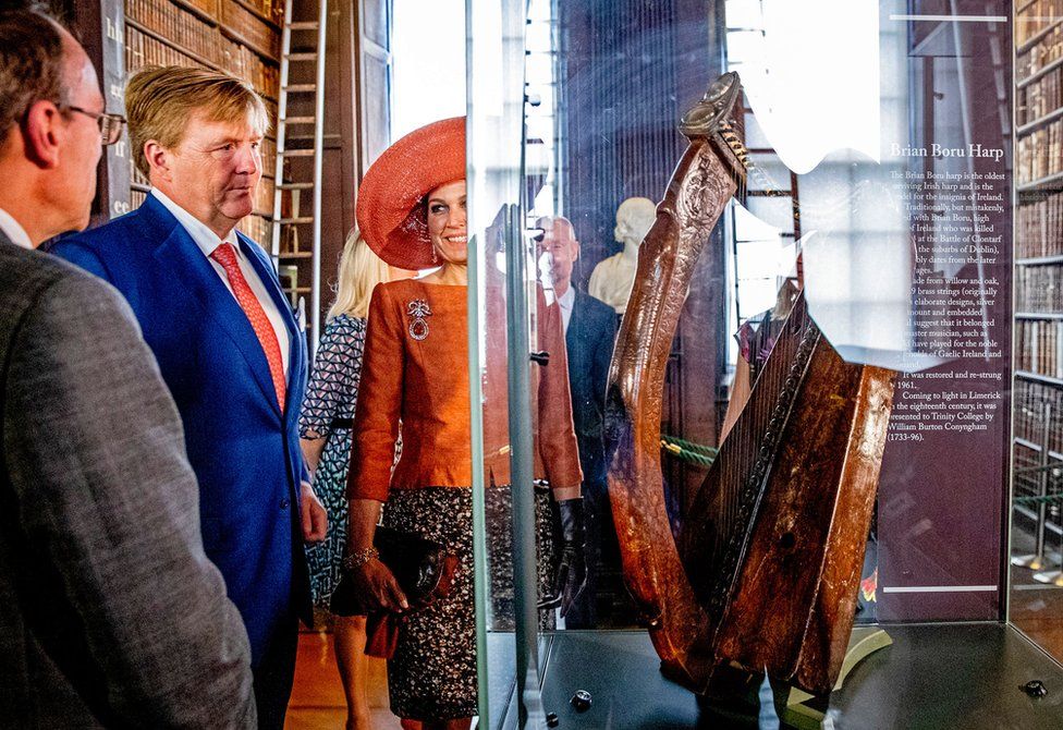King Willem-Alexander and Queen Maxima of The Netherlands look at an artefact in the Long Room Library in Trinity College Dublin, Ireland