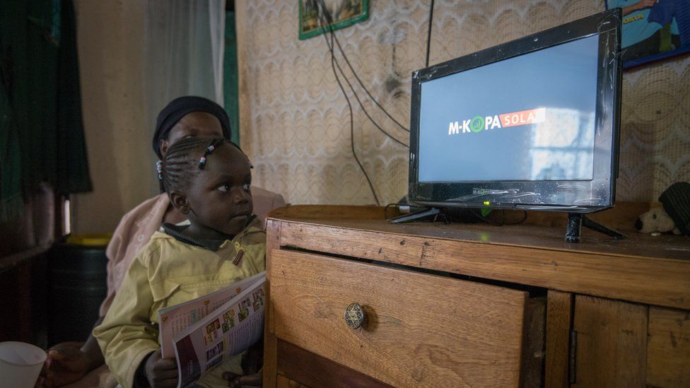 Young girls watching solar-powered TV