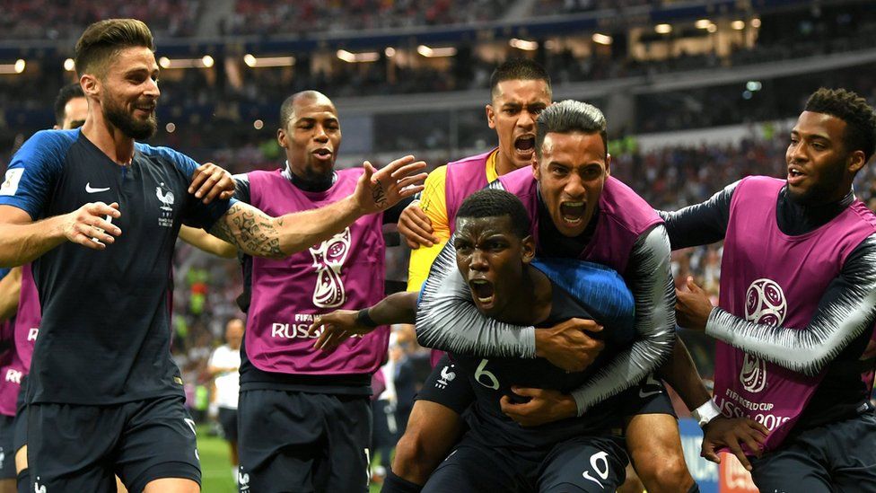 France's Paul Pogba celebrates with teammates after scoring the third of France's four goals