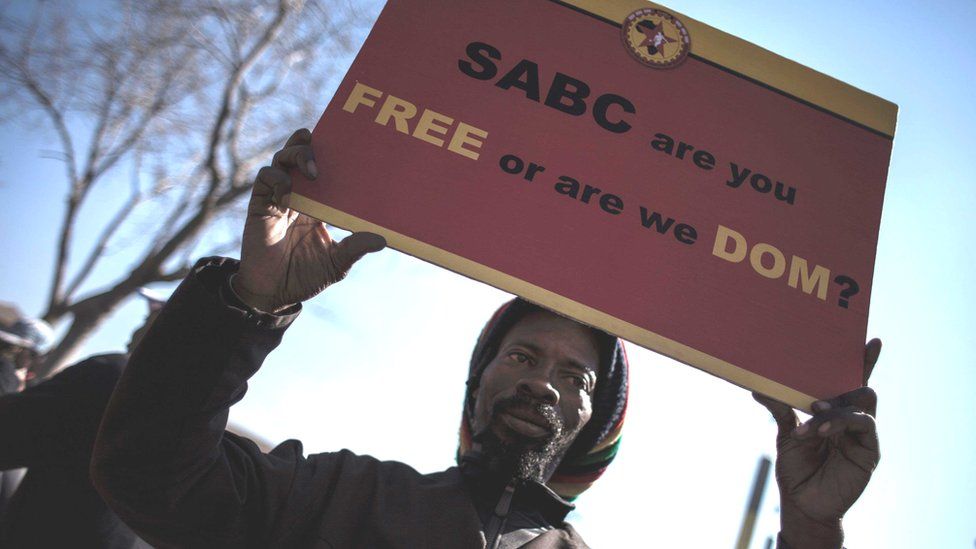 A protester at a rally outside the Johannesburg Constitutional Court in July 2016 in to protest against alleged bias and self-censorship in news coverage by the South African Broadcasting Corporation (SABC)