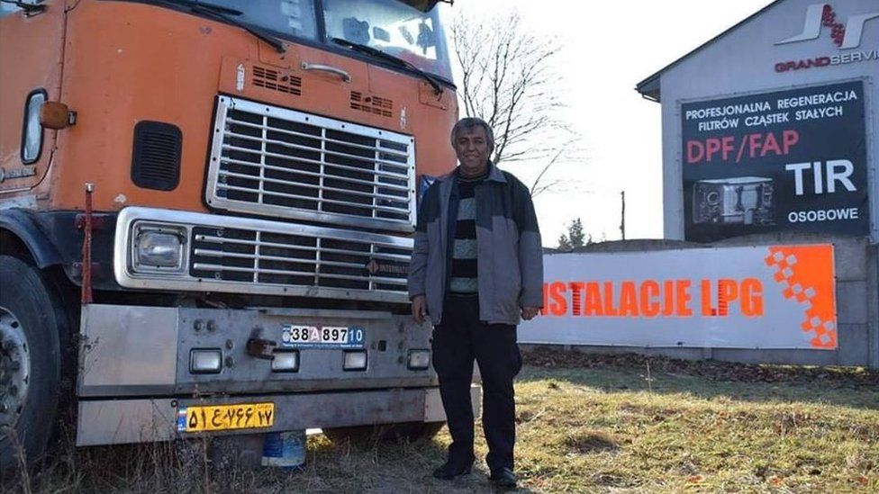 Fardin Kazemi in front of his broken down American International 9670 lorry