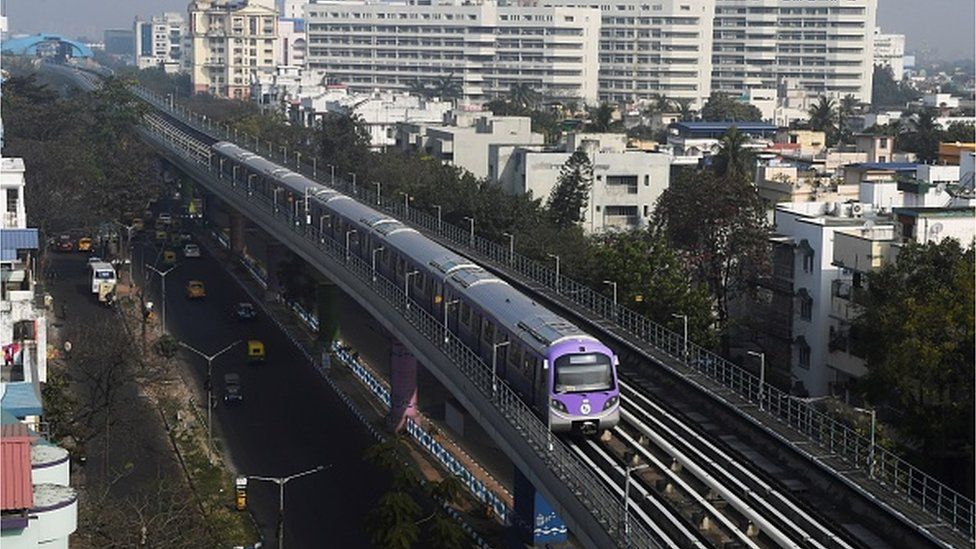 train of the East-West metro line moves along an elevated metro tracks during its first day of commercial run in Kolkata on February 14, 2020.