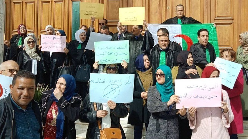 Algerian judges hold placards as they protest against President Bouteflika's bid for a fifth term in power, in the north-eastern city of Annaba on 11 March 2019